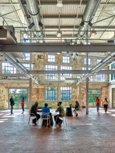 An image of the inside of the revitalized Packing House building featuring an open concept space where people can meet and collaborate.